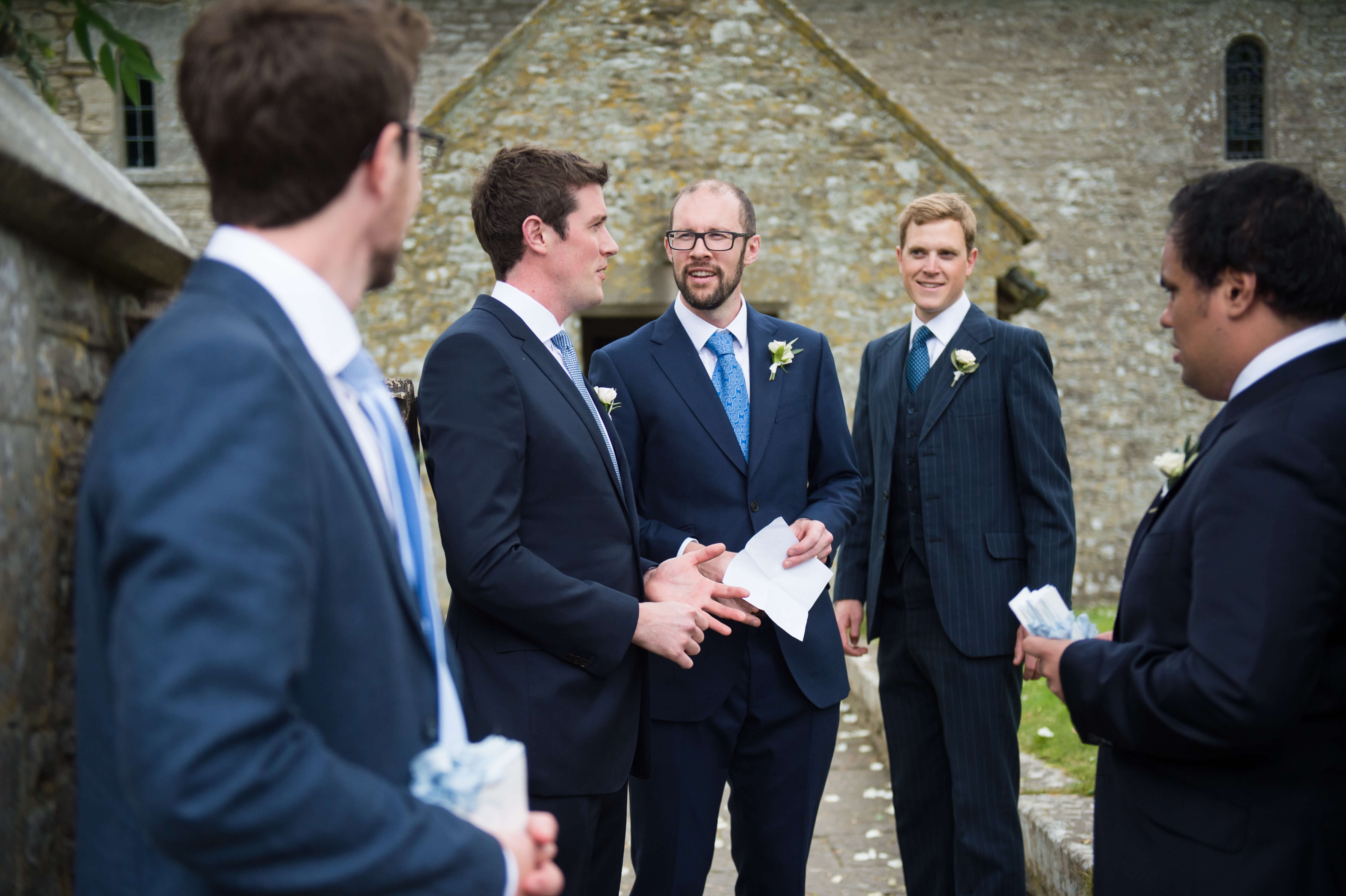 groom and ushers outside the church before a wedding in dorset